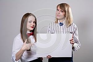 Two beautiful girls with a banner