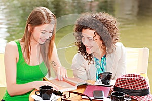 Two beautiful girls chatting over a coffee