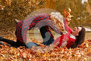 Two beautiful girls friends having fun in autumn park