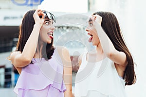 Two beautiful girls having fun on the street