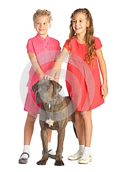 Two beautiful girls joyfully stroking a big dogs photo