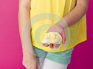 Two beautiful girls playing with homemade slime and having a lot of fun in front of pink background