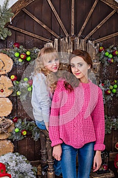 Two beautiful girls posing in Christmas decorations