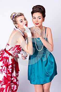 Two beautiful girls in a vintage dress telling tales