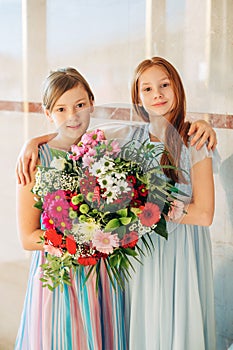 Two beautiful girls wearing occasional dresses