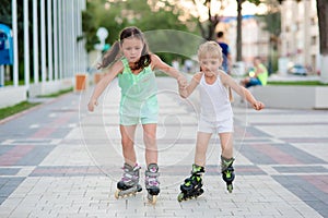 Two beautiful little sisters in a roller skates