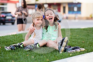 Two beautiful little sisters in a roller skates