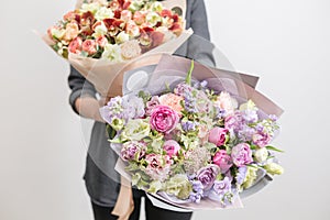 Two beautiful luxury bouquet of mixed flowers in woman hand. the work of the florist at a flower shop. A small family