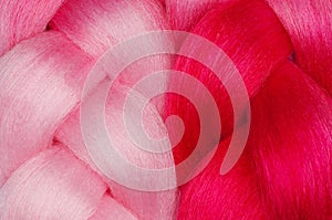 Two beautiful pink kanekalon close-up. Hairstyles and hair care