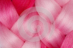 Two beautiful pink kanekalon on white background close-up.