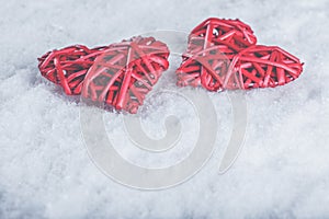 Two beautiful romantic vintage red hearts together on a white snow background. Love and St. Valentines Day concept.