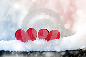 Two beautiful romantic vintage red hearts together on a white snow winter background. Love and St. Valentines Day concept