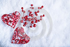 Two beautiful romantic vintage red hearts together on white snow winter background. Love and St. Valentines Day concept