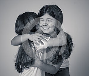 Two beautiful sisters hugging each other in happy moments together