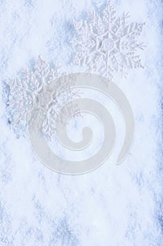 Two beautiful sparkling vintage snowflakes on a white frost snow background. Winter and Christmas concept