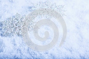 Two beautiful sparkling vintage snowflakes on a white frost snow background. Winter and Christmas concept