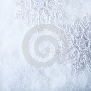 Two beautiful sparkling vintage snowflakes on a white frost snow background. Winter and Christmas concept