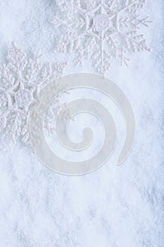 Two beautiful sparkling vintage snowflakes on a white frost snow background. Winter and Christmas concept