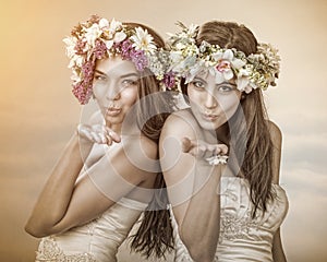 Two beautiful spring fairy , brides sending a kiss to you