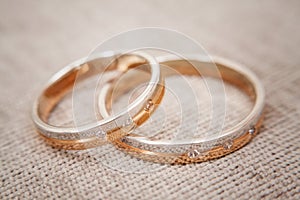 Two beautiful wedding rings with brilliants close up. Selective focus