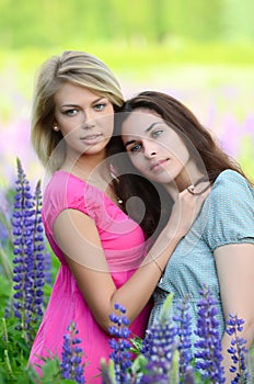 Two beautiful woman in field with lupin