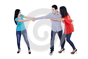 Two beautiful woman fighting over man