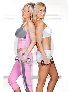 Two beautiful women in fitness outfit