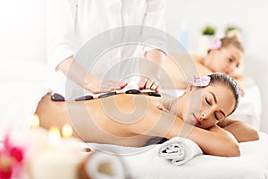 Two beautiful women getting massage in spa