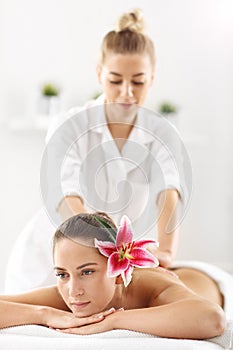 Two beautiful women getting massage in spa