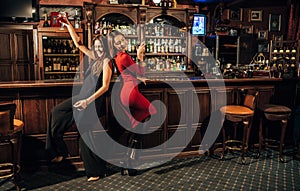 Two beautiful women having fun at the bar