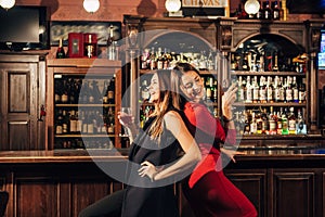 Two beautiful women having fun at the bar