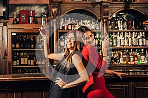 Two beautiful women having fun at the bar