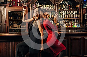 Two beautiful women having fun at the bar