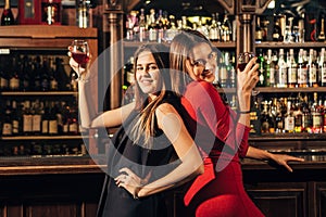 Two beautiful women having fun at the bar