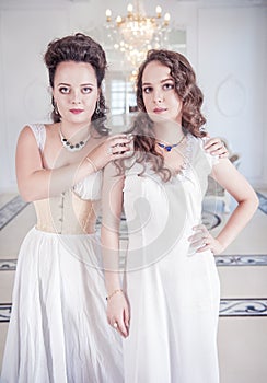 Two beautiful women in old-fashioned negligee