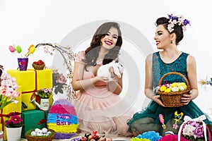 Two beautiful women playing in easter decoration with a rabbit.