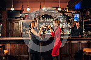 Two beautiful women are relaxing in the bar