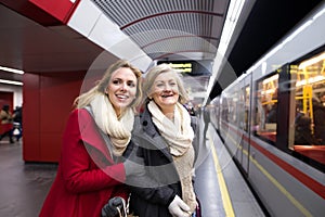 Two beautiful women at the underground platform, travelling