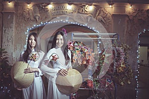 Two Beautiful women wearing Ao Dai Vietnamese