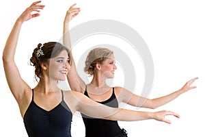 Two beautiful young girls making exercise or dancing together
