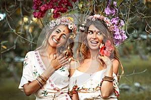 Two beautiful young woman in summer dresses outdoors