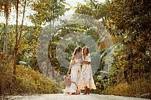 Two beautiful young woman in summer dresses outdoors at sunset