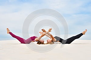 Two beautiful young women doing steamy yoga