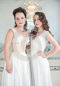 Two beautiful women in old-fashioned negligee