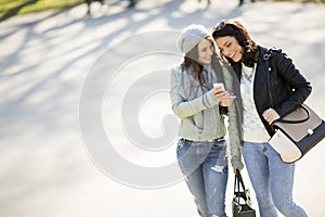 Two beautiful young women walking and talking in the