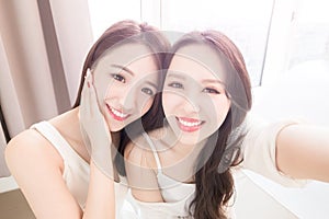 Two beauty woman selfie happily