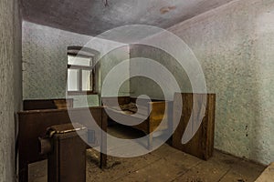 two beds made of wood in a old room