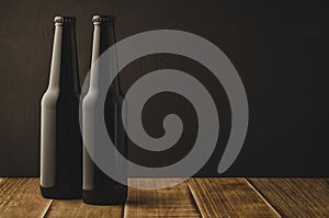 two beer bottles on a wooden table against a dark background/two beer bottles on a wooden table against a dark background,