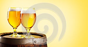 Two beer glasses on wooden barrel