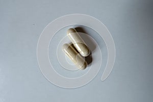 Two beige capsules of Saccharomyces boulardii probiotic from above